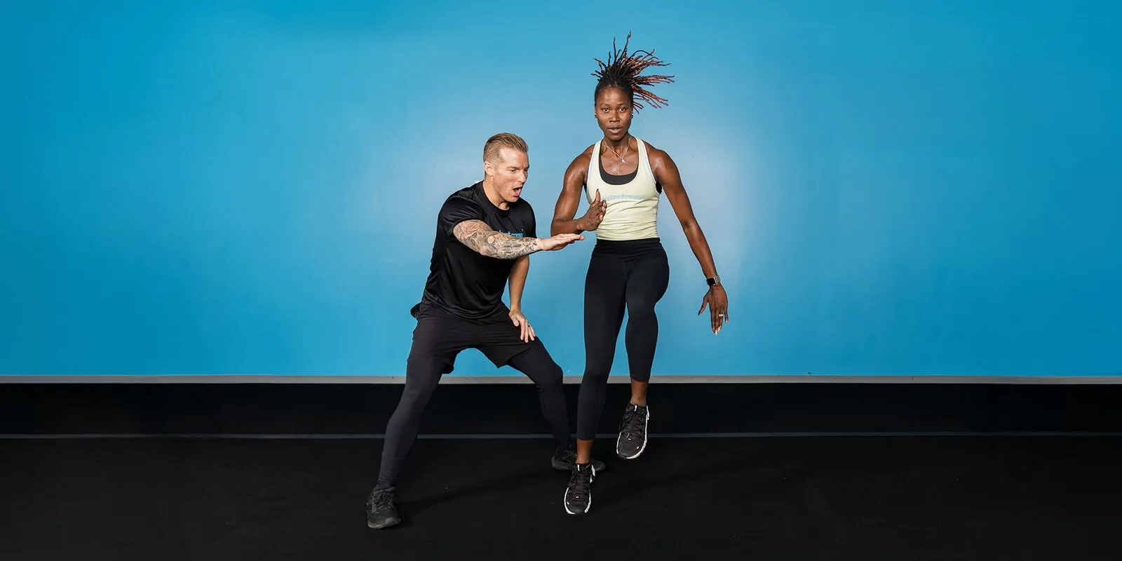 A Burn Trainer giving personal guidance during a gym workout